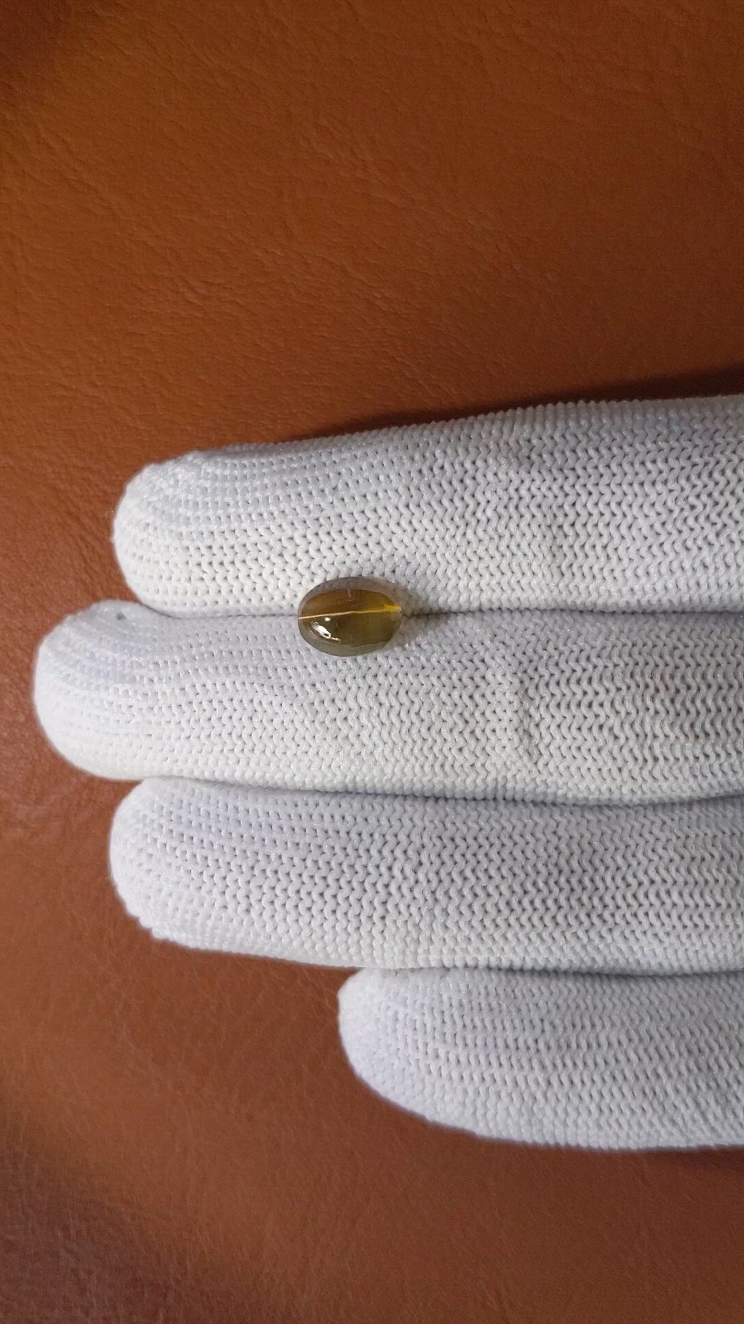 2.32 Ct. Yellowish Brown Cabochon Kornerupine from Ceylon (Sri Lanka) Size Video